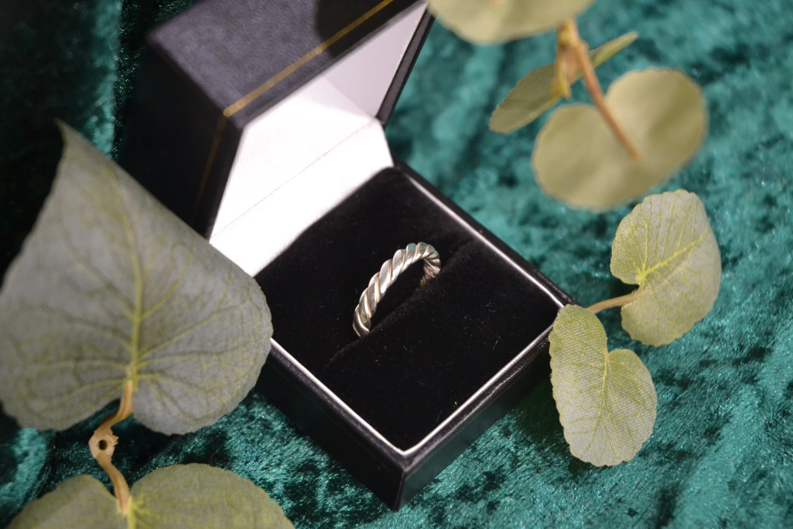 Custom made twisted silver wedding band in a black presentation box, a bespoke jewellery creation by Alexander Jewellery Chichester.