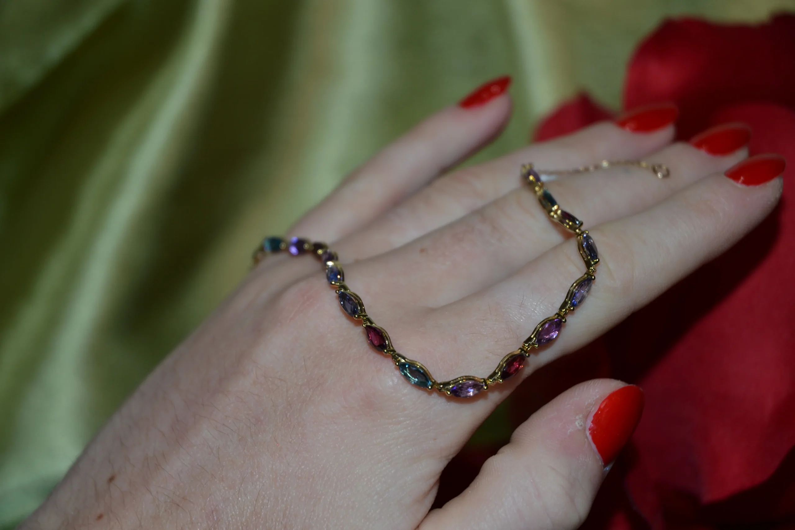 Hand modelling a custom multi-gemstone gold bracelet featuring marquise-cut stones, designed by the expert jewellers at Alexander Jewellery in Chichester.